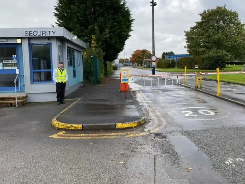 Construction site security guard monitoring access UK